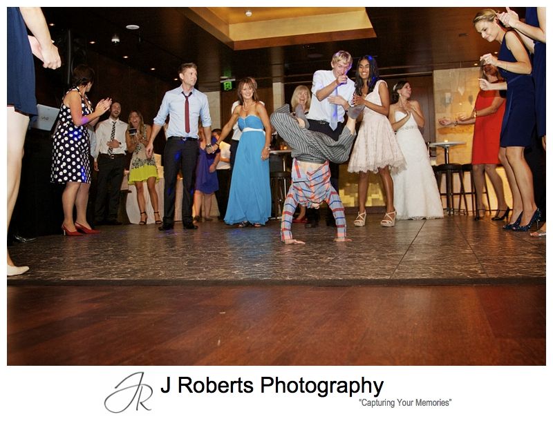 Groovy page boy break dancing at wedding reception - sydney wedding photography 